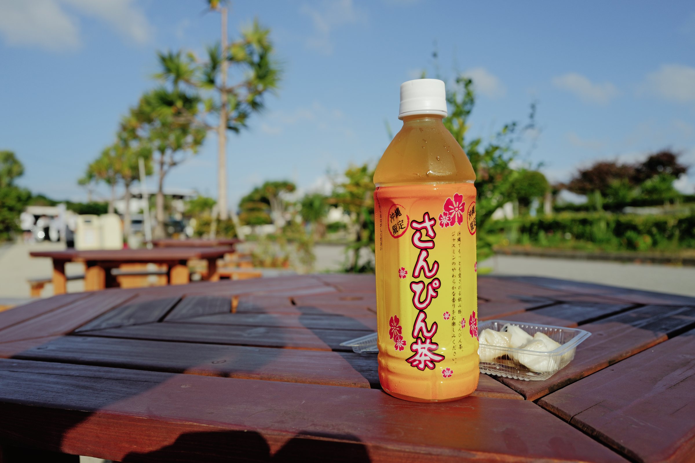 外のテーブルに置かれた、さんぴん茶のペットボトル