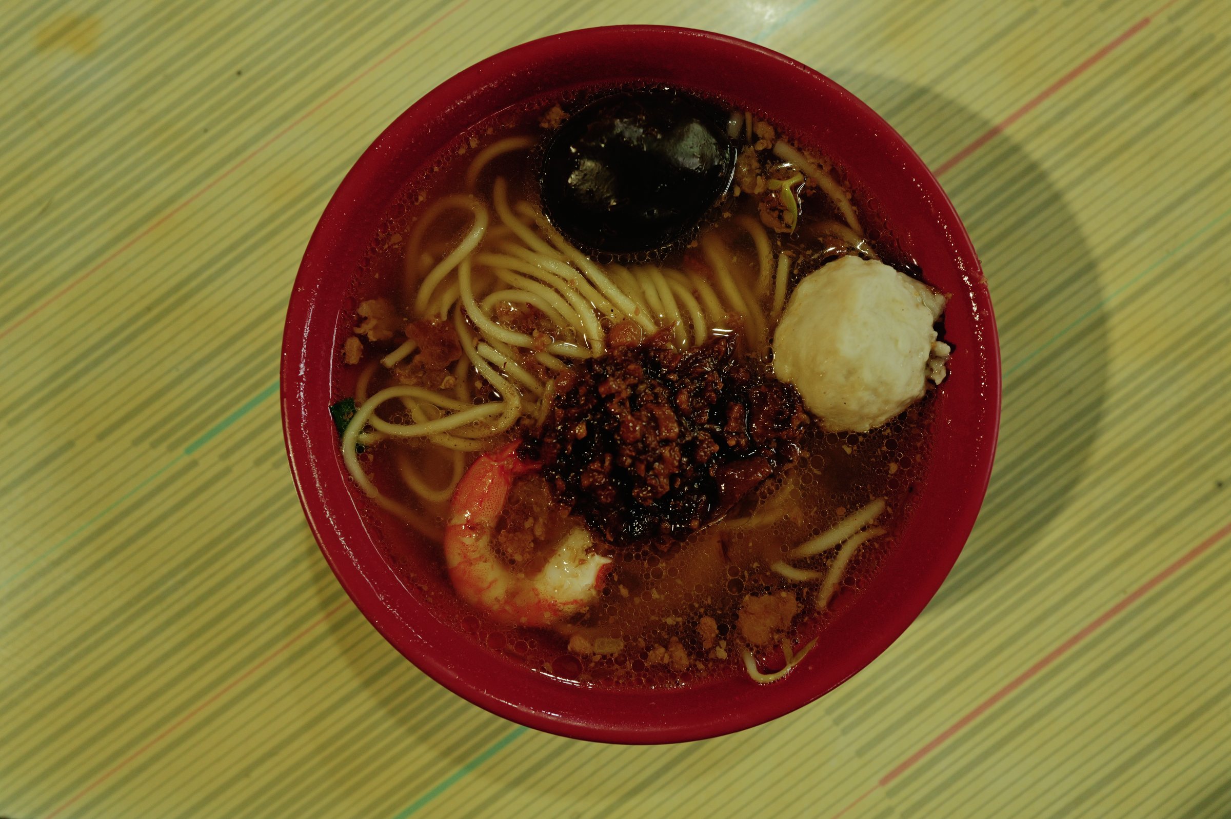 赤い器の担仔麺。肉そぼろと海老と煮卵がのっている